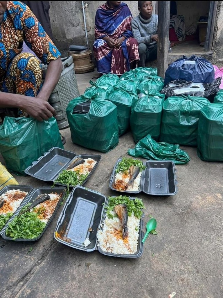 Packed green bundles and freshly prepared takeaway food containers featuring whole fish, rice, and fresh greens ready for ARF Ramadan distribution across 10 states